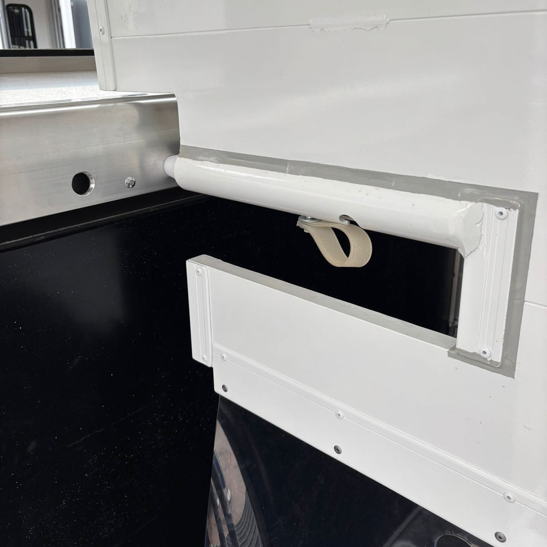 Close-up of the breast bar attachment and partition hardware inside the horse area