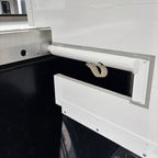 Close-up of the breast bar attachment and partition hardware inside the horse area