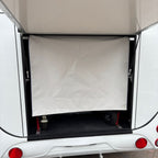 Rear loading area with the canvas weather curtain pulled down across the ramp opening