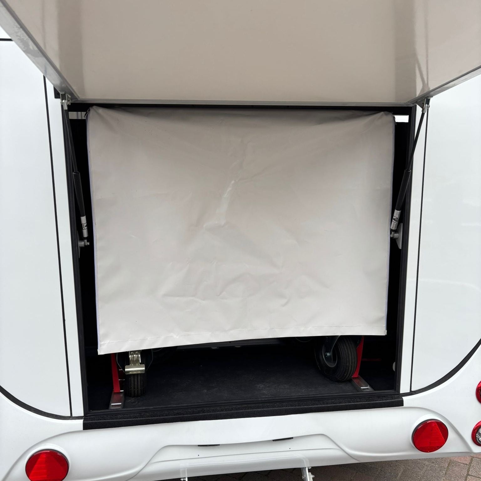 Rear loading area with the canvas weather curtain pulled down across the ramp opening