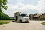 Theault XTEO horsebox parked in a courtyard in front of a traditional timber-framed Normandy stable