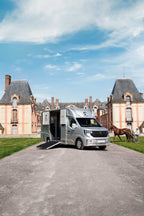 Rear three-quarter view of a Theault Aero Master horsebox in a courtyard
