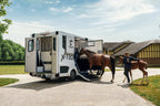 Theault XTEO horsebox with the ramp down and two horses being loaded by a handler