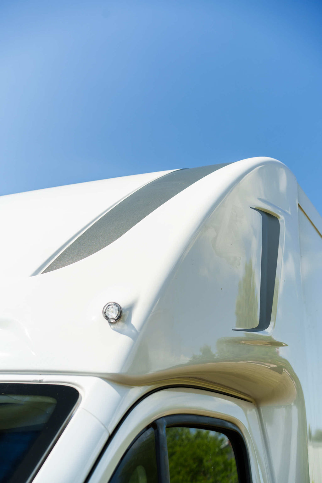 Close-up of the profiled over-cab luton pod on a Theault XTEO horsebox against a blue sky