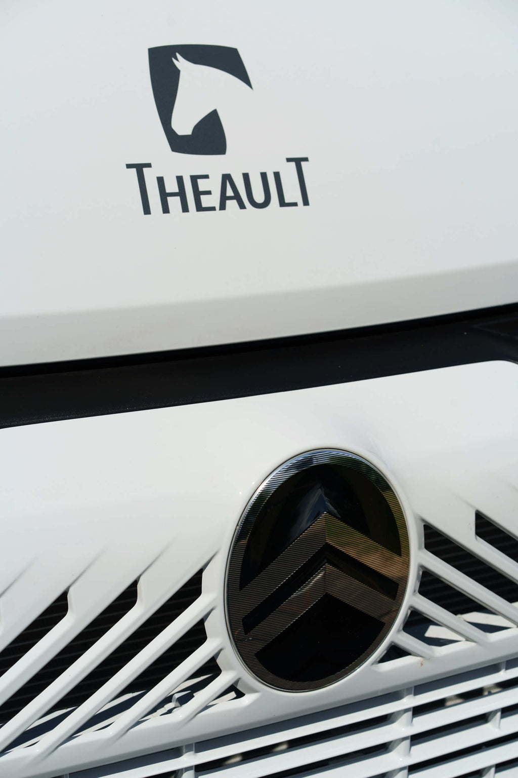 Front grille and chassis badge detail of a Theault XTEO horsebox