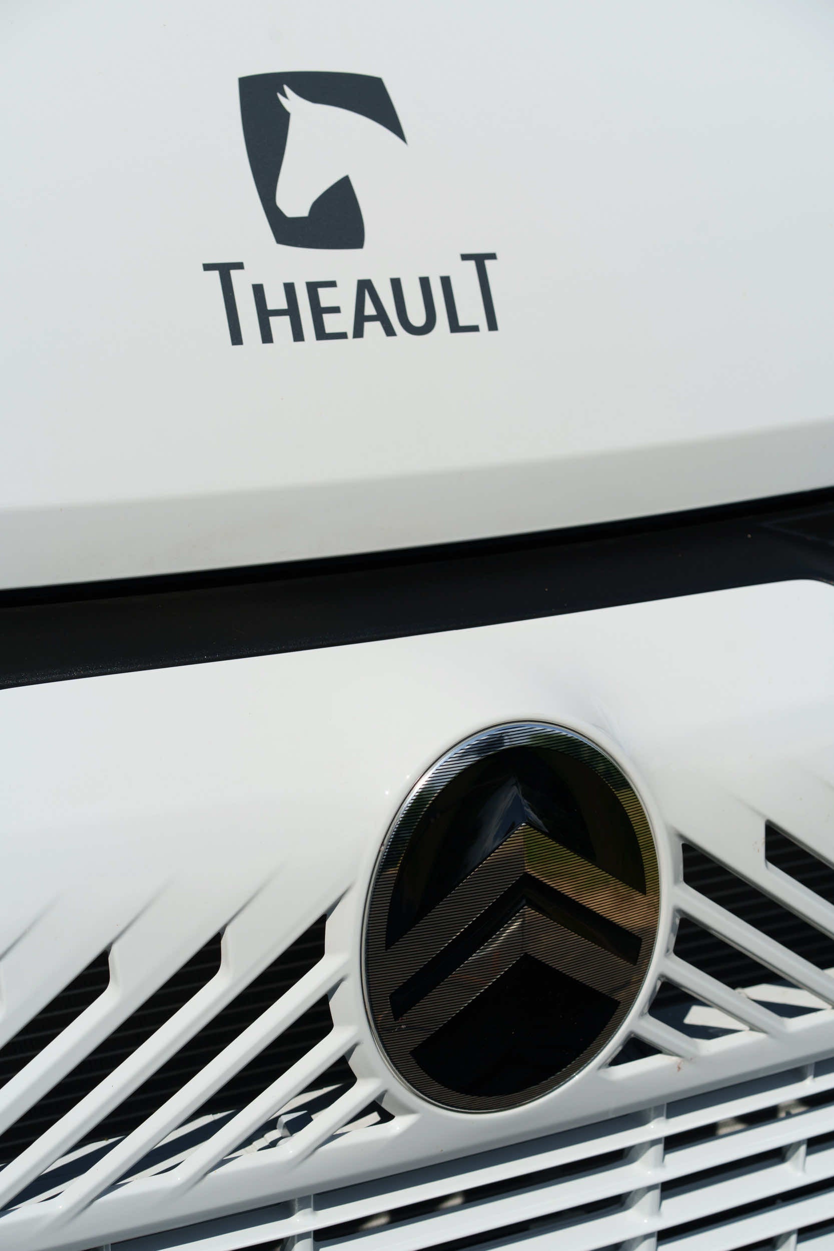 Front grille and chassis badge detail of a Theault XTEO horsebox