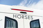 Side body detail of a Theault XTEO horsebox with HORSES lettering and red marker light