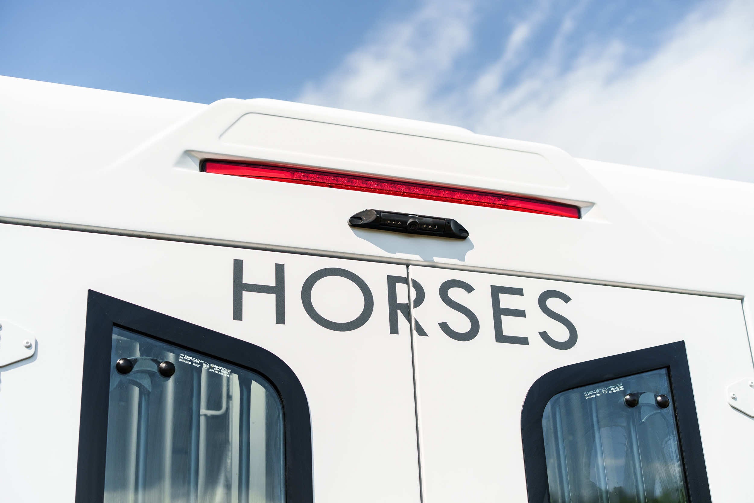 Side body detail of a Theault XTEO horsebox with HORSES lettering and red marker light