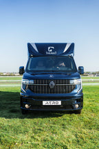 Head-on front view of a Theault Aero Master horsebox in a field