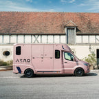 Front three-quarter view of a Theault Aero Sprinter horsebox by a stable
