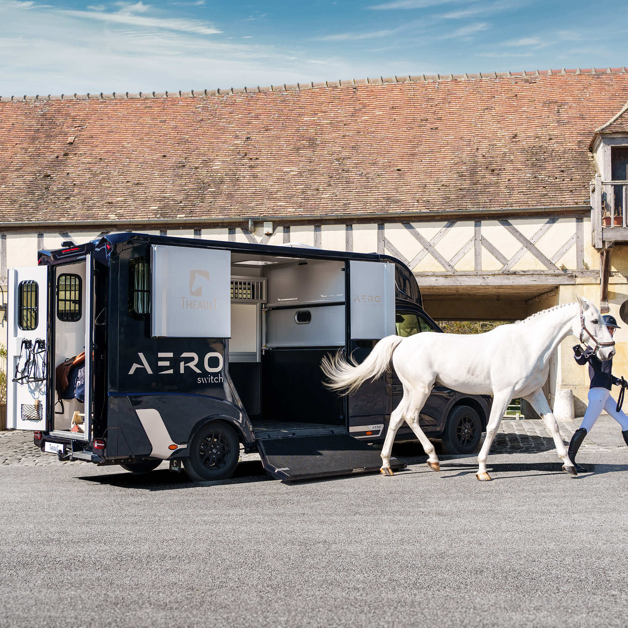 Theault Aero Master horsebox with horses being loaded outside a Normandy stable